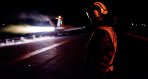 111203-N-OY799-381 A U.S. Navy sailor observes as an aircraft launches during night flight operations on the flight deck of the aircraft carrier USS John C. Stennis (CVN 74) in the Arabian Gulf on Dec. 3, 2011. The Stennis is deployed to the U.S. 5th Fleet area of responsibility conducting maritime security operations and support missions as part of Operations Enduring Freedom and New Dawn. DoD photo by Petty Officer 3rd Class Kenneth Abbate, U.S. Navy. (Released)
